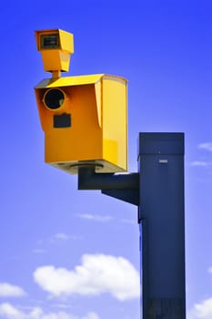 Traffic speed camera over the blue sky.