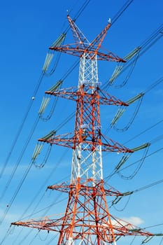 Power pylon over blue sky. Electrical transmission tower.