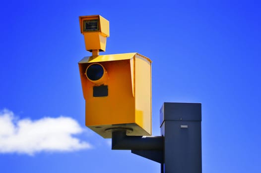 Traffic speed camera over the blue sky.