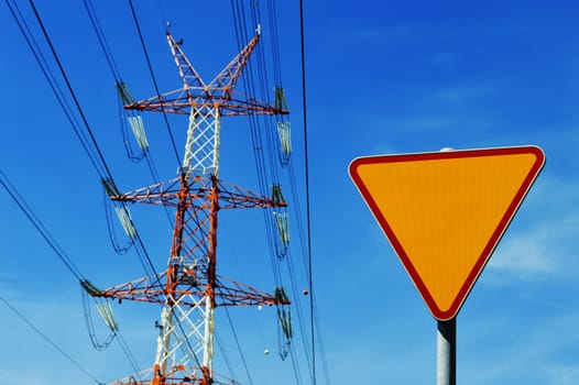 Power pylon over blue sky. Electrical transmission tower.