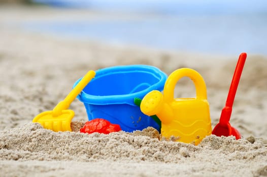 Plastic children toys on the sand beach