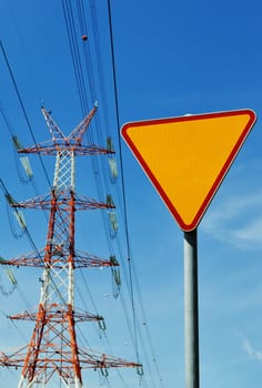 Power pylon over blue sky. Electrical transmission tower.