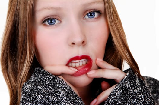 A pretty teenager's face in closeup with her finger's on her lips,.isolated for white background..