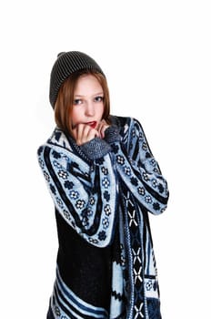 A young teenager girl in a blue-grey sweater and knitted hat standing, .isolated for white background..