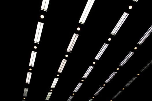 Rows of fluorescent lamps of office ceiling