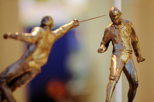 The fencing statues in action of attacking