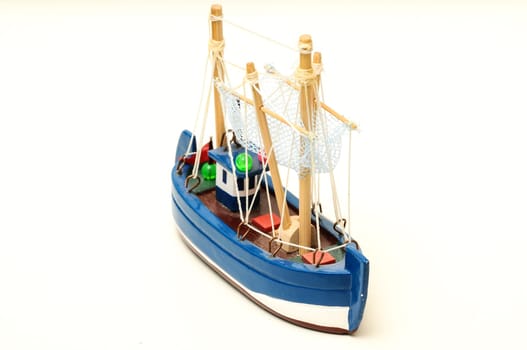 Beautiful miniature ship. Wooden sailship figurine. Antique model sailing boat isolated on white