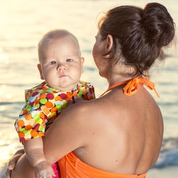 Baby and mother on the tropical beach
