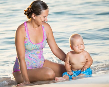 Baby and mother on the tropical beach