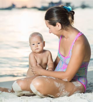 Baby and mother on the tropical beach