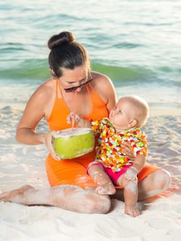 Baby and mother on the tropical beach
