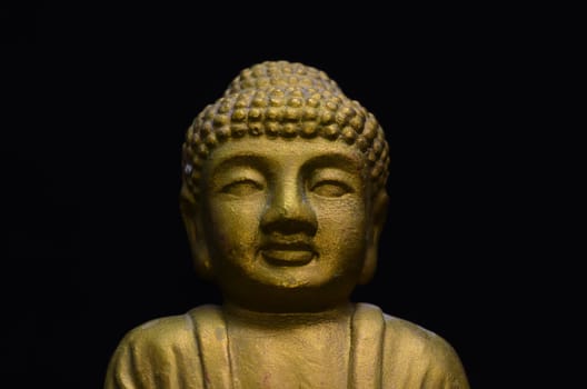 Golden Buddha Statue on a Black Background