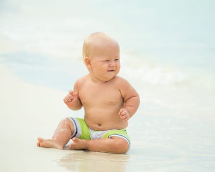 Cute baby on the tropical beach