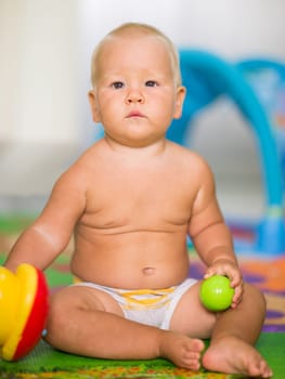 Cute baby is playing toy