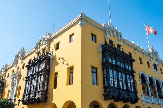 Colonial yellow building at main square called Plaza de Armas, Lima, Peru