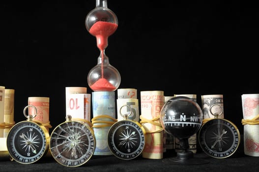 Business Time Concept Money and Hourglass on a Black Background