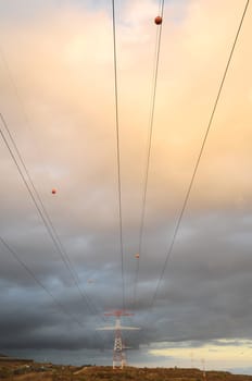 Power Electric Tower on a Cloudy Sky at Sunset