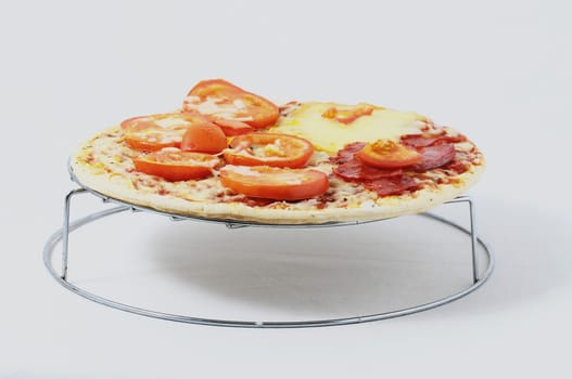 Cooked Mixed Italian Pizza over a White Background