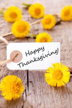 White Label with Happy Thanksgiving on it and many yellow Flowers