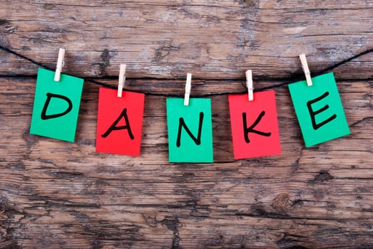 The German Word Danke, which means Thanks, on a Line on Wood