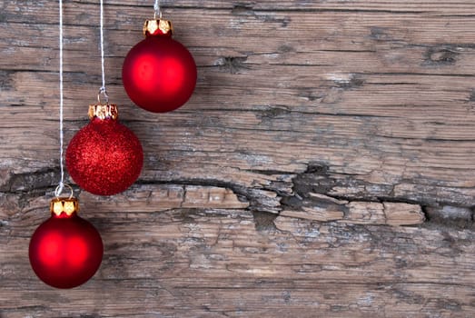 Three Red Christmas Tree Balls on Wood with Copy Space