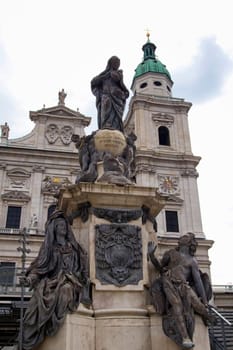 The facade of the Basilica of St. Peter in Salzburg (Austria). Marian column, whose peculiarity is the base of a marble and statue of the lead.