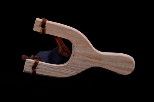 Classic Toy Wooden Sling Isolated on a Black Background