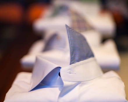 Close up of white male shirts exposed in the clothes shop