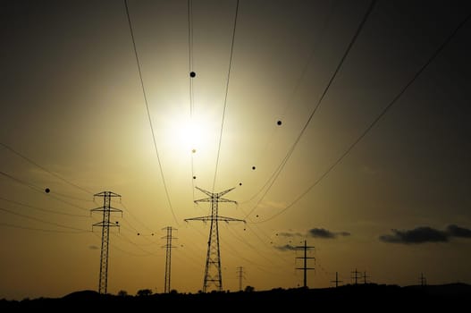 Electric Power Line Pylon over a colored Sunset
