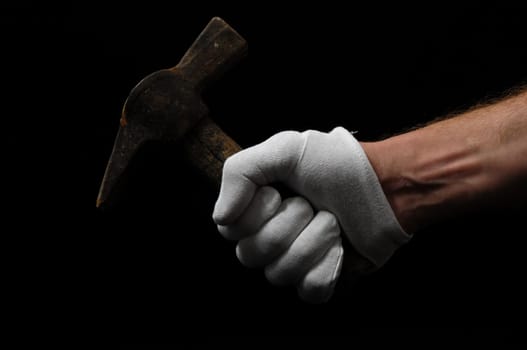 Hammer and a Hand on a Black Background
