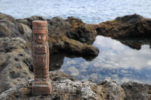 Ancient Maya Statue on the Rocks near Ocean