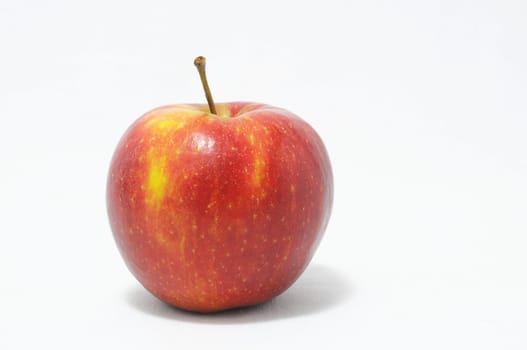 One Juicy Hot Red Apple over a White Background