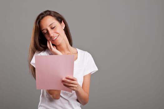 a young woman reading a love letter