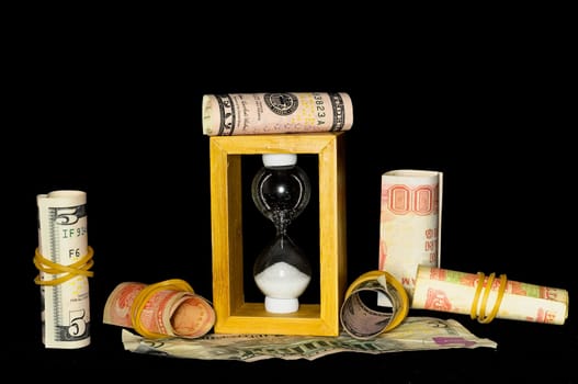 Buisness Time Concept Hourglass and Money on a Black Background