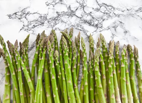 Fresh green asparagus on background in marble