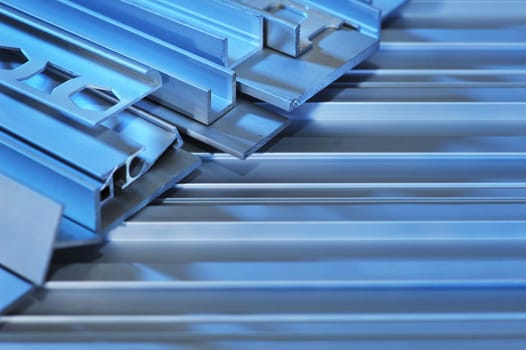 many different aluminium profile strips in blue light