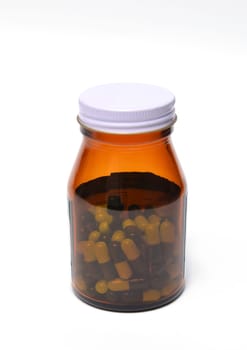 group of green capsule medicine in bottle on white background
