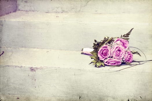 Vintage photo of pink wedding bouquet on the stairs