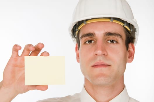 Head-and-shoulder view of a young man in a white shirt and white construction site helmet showing a palm-sized map into the camera against a white background Look neutrally into the camera