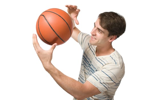 Torso view of a young man in a striped T-shirt against a white background juggling a basketball and looking contentedly at the ball