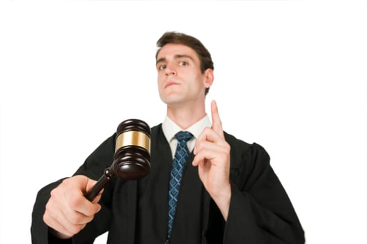 Upper body view of a young man in Richter-Robe against a white background with Gravel (judge hammer) in his right hand seriously and looking into the camera with his index finger raised