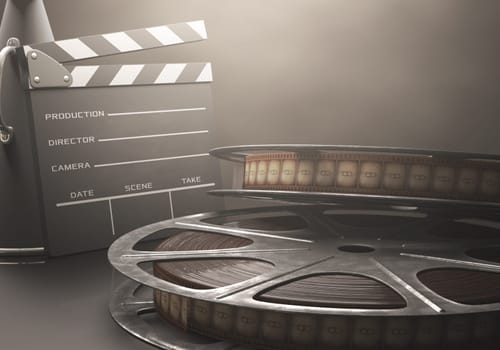 Clapperboard with rolls of film in the retro concept cinema.