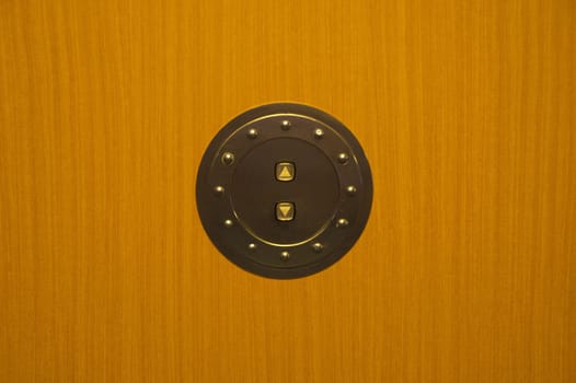elevator,elevator,button,switch,up,down,up,down,brown,wood,wall,shield,metal,ring