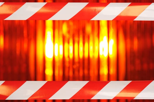 Construction site background with macro detail of an orange all-round light and two original shut-off strips