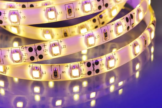 Macrodetail of a warm white LED strip in coloured light