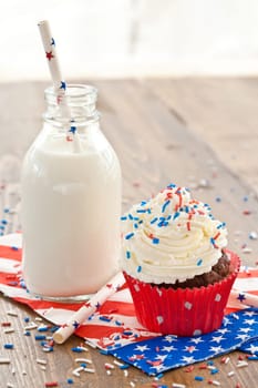 Small cupcake with buttercream and milk