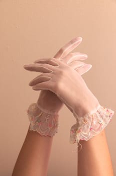 Image of woman's forearms and hands modeling vintage lace see through gloves.