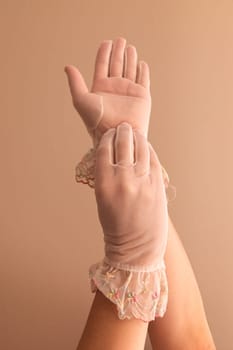 Image of woman's forearms and hands modeling vintage lace see through gloves.