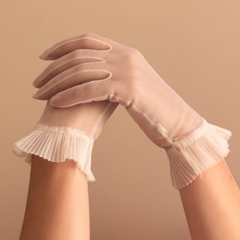 Image of woman's forearms and hands modeling vintage sheer see through gloves.