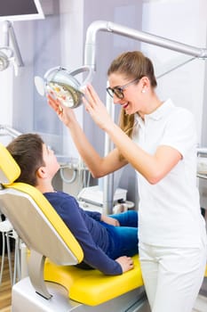 Dentist giving patient advice in dental surgery